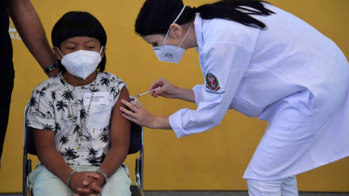 Brazilian indigenous boy Davi Xavante -the first child in Brazil to get vaccinated against Covid-19- receives the first dose of the Pfizer-BioNTech vaccine at the Clinicas hospital in Sao Paulo. — AFP