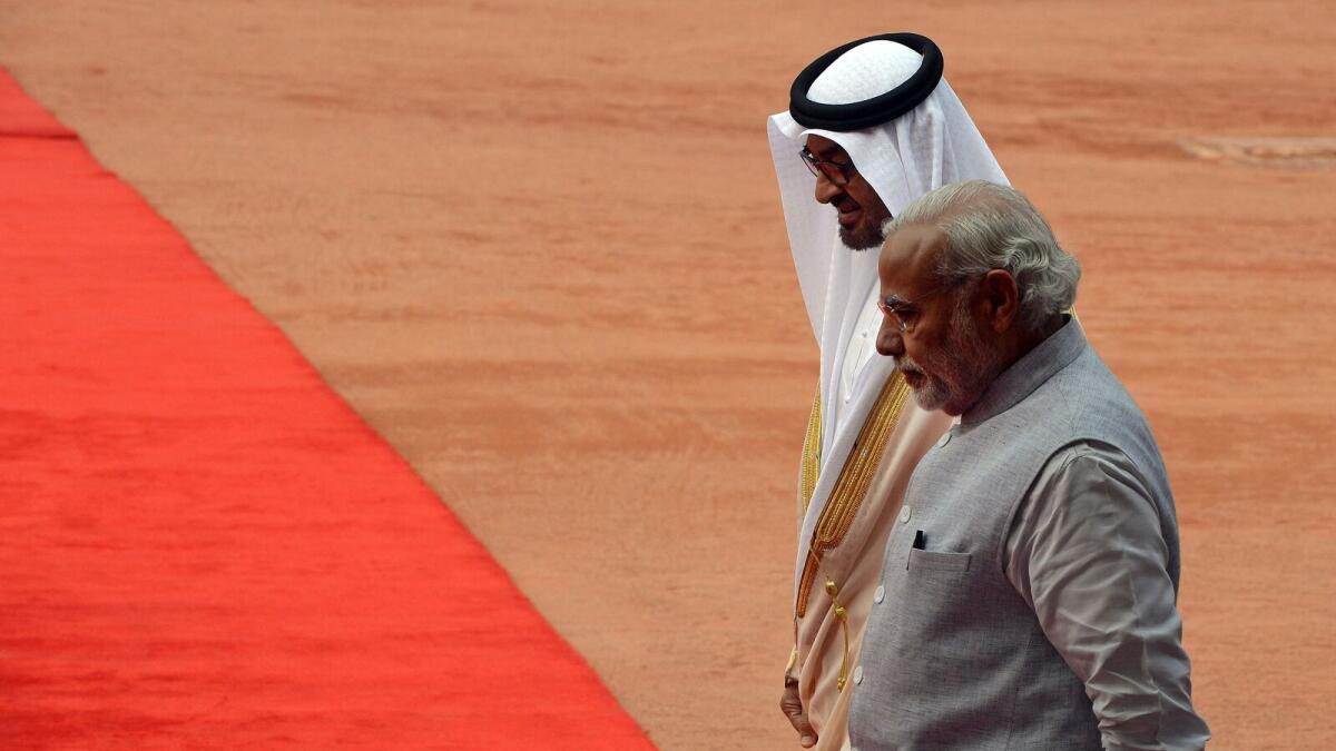 India's Prime Minister Narendra Modi walks with visiting His Highness Shaikh Mohammed bin Zayed Al Nahyan, Crown Prince of Abu Dhabi and Deputy Supreme Commander of the UAE Armed Forces, during a ceremonial reception at the presidential palace in New Delhi on February 11, 2016.