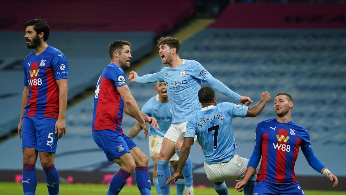 Manchester City's John Stones (centre) celebrates after scoring a goal against Crystal Palace during the English Premier League match. — AP