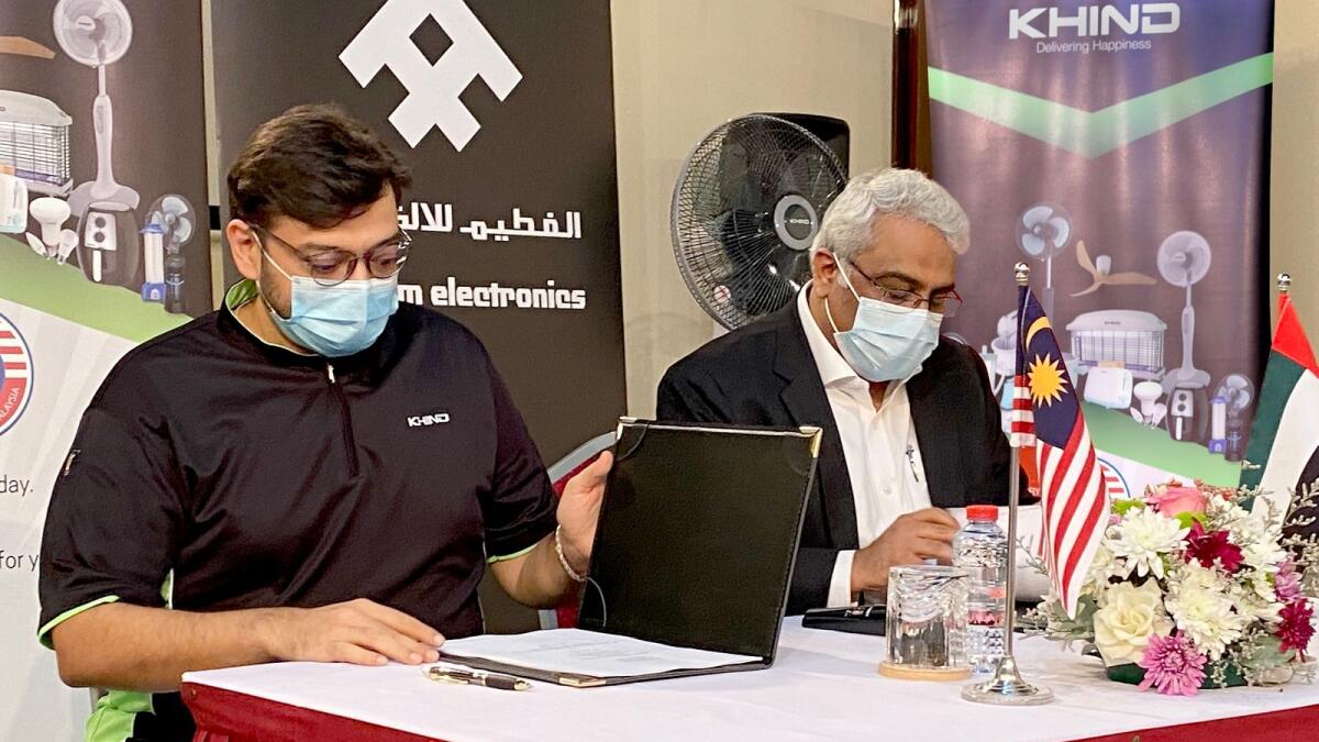 Adil Mistry, group chief executive officer, Khind Holdings Berhad; and Sachin Wadhwa, managing director of Al Futtaim Electronics, sign an agreement to distribute Khind products in the UAE. — Supplied photo