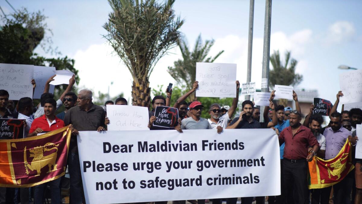 Sri Lankans living in the Maldives stage a demonstration in Male to protest against the arrival of President Gotabaya Rajapaksa. – AFP
