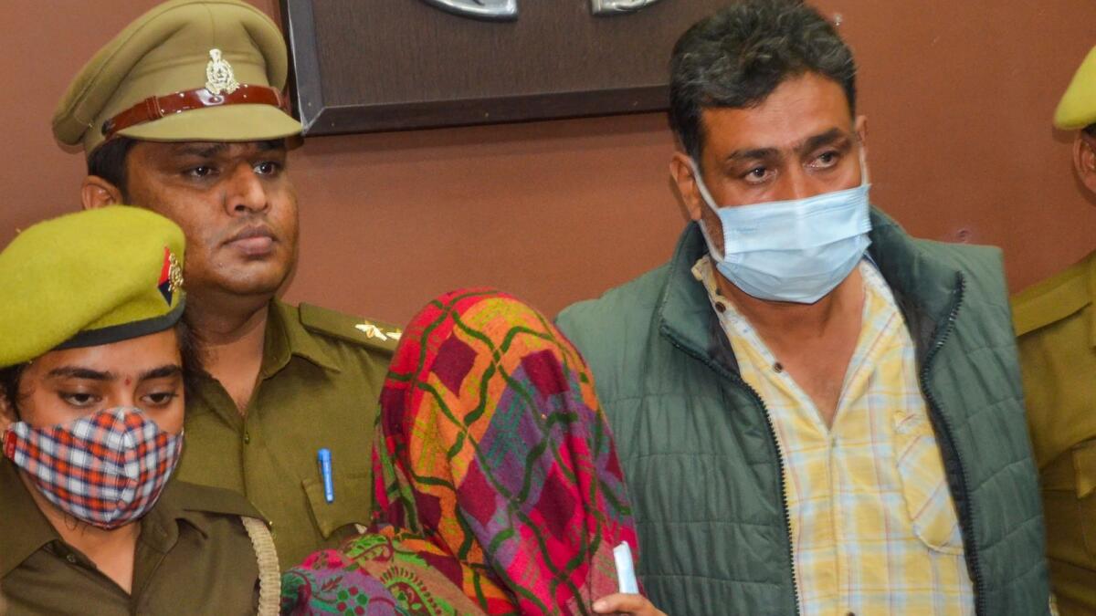 Police with accused Nitish Yadav and Braj Bala, who allegedly killed their daughter Ayushi Yadav and stuffed her body in a trolley bag. — PTI
