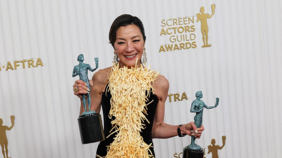 Michelle Yeoh poses backstage with the  Outstanding Performance by a Female Actor in a Leading Role and Outstanding Performance by a Cast in a Motion Picture awards for 'Everything Everywhere All at Once'