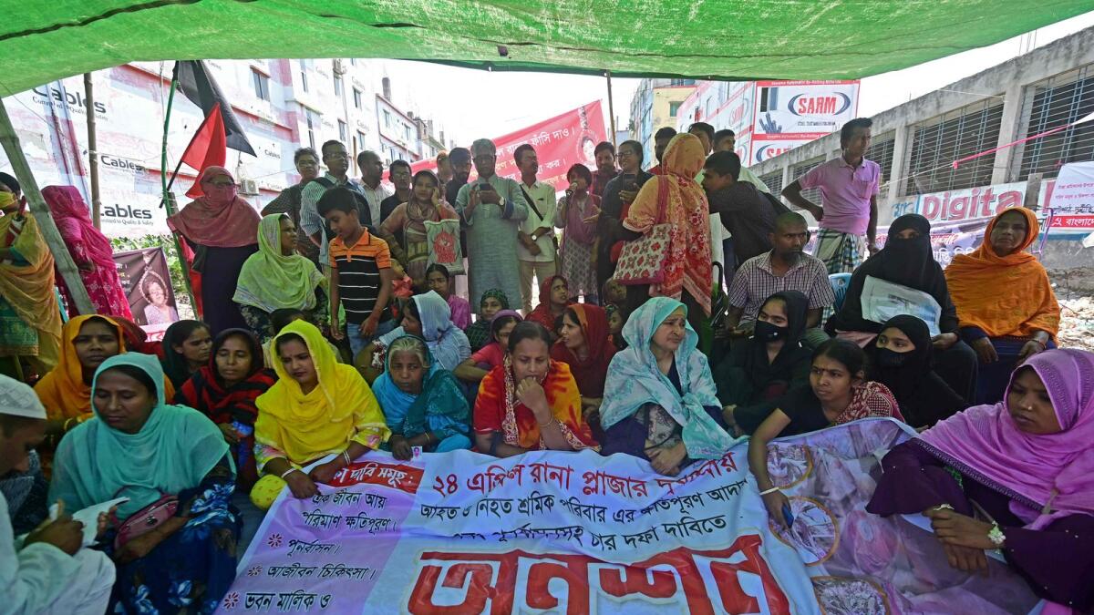 Victims of the Rana Plaza garments factory tragedy stage a hunger strike on its 10th anniversary at the site where the building once stood in Savar on the outskirts of Dhaka on Monday. — AFP