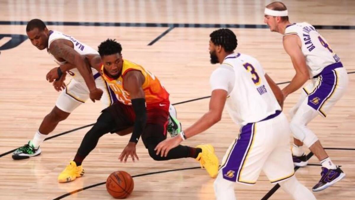 Utah Jazz guard Donovan Mitchell (45) tries to control the ball between Los Angeles Lakers players Dion Waiters (left) , Anthony Davis (3) and Alex Caruso (4) during the second half. (Reuters)
