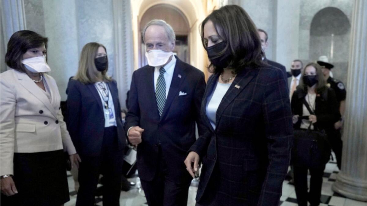 Kamala Harris walks with Senator Tom Carper following meetings at the US Capitol in Washington. — Reuters