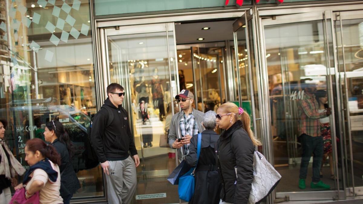 Shoppers walk along Lexington Avenue in the eastern Midtown section of Manhattan in New York City. — AFP file photo