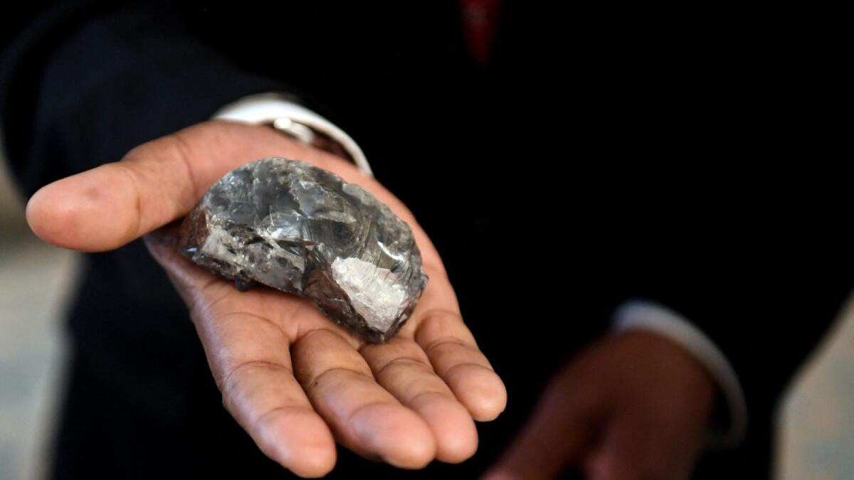 A member of the Botswana cabinet holds a 1,174-carat diamond found in Gaborone, Botswana. Photo: AFP