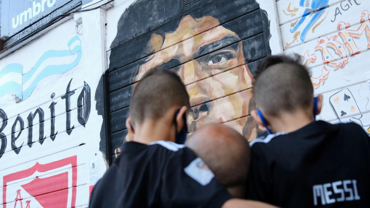 Fans gather to mourn the death of soccer legend Diego Maradona, outside the Diego Armando Maradona stadium, in Buenos Aires, Argentina November 25, 2020.  Reuters