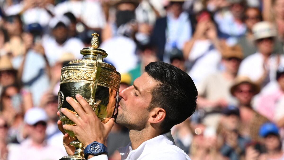 Novak Djokovic kisses the trophy after defeating Nick Kyrgios in the final. (AFP)
