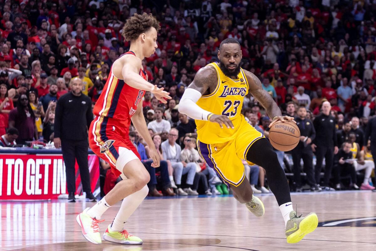 Los Angeles Lakers forward LeBron James (23) dribbles against New Orleans Pelicans guard Dyson Daniels (11). — Reuters
