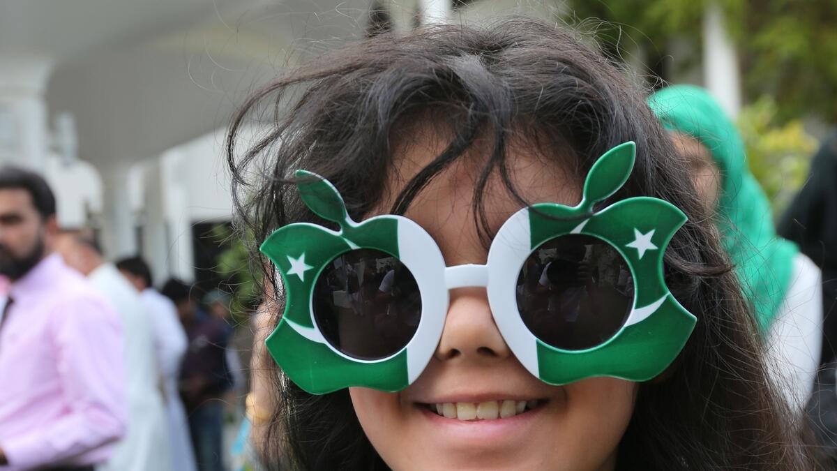 A girl wearing customised prop glasses adorned in the official flag colours of Pakistan during the celebrations. (Ryan Lim/KT)
