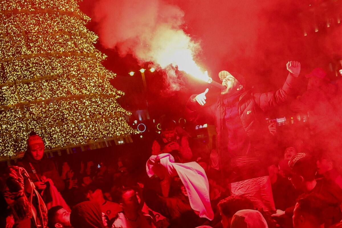 Morocco fans celebrate as they gather in Sol square after the Fifa World Cup Qatar 2022 match between Spain and Morocco, in Madrid. Photo: Reuters