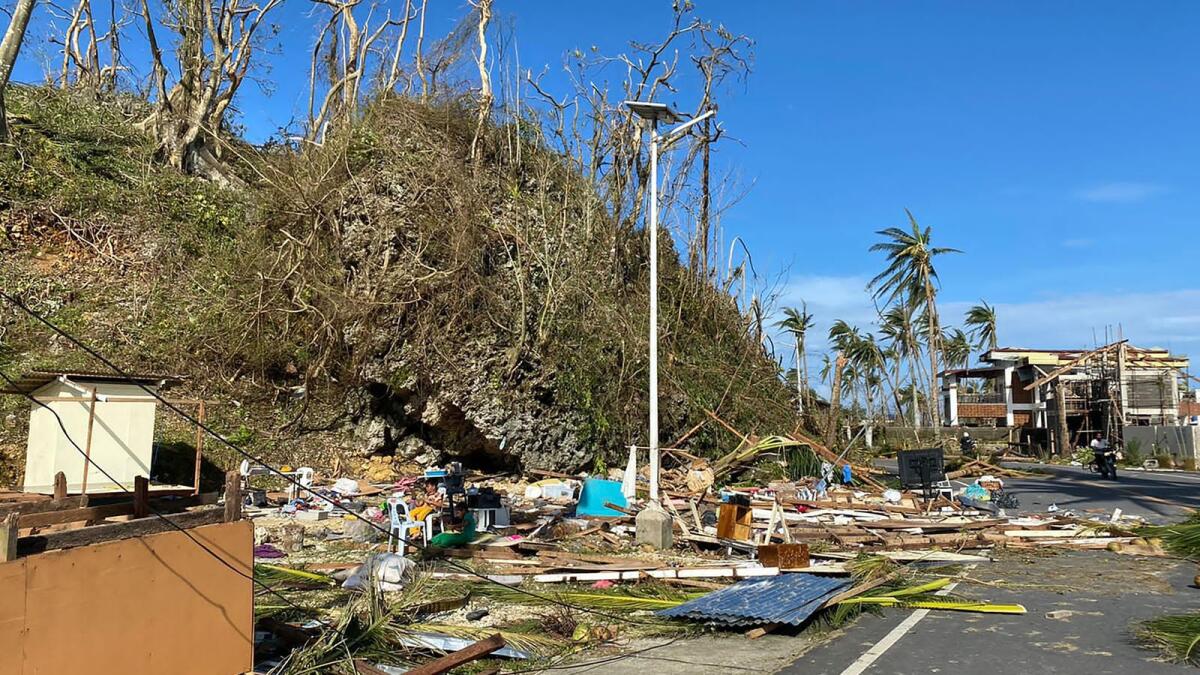 Debris litter along a highway in General Luna town, Siargao island, Surigao del norte province, a day after super Typhoon Rai devastated the island. Photo: AFP
