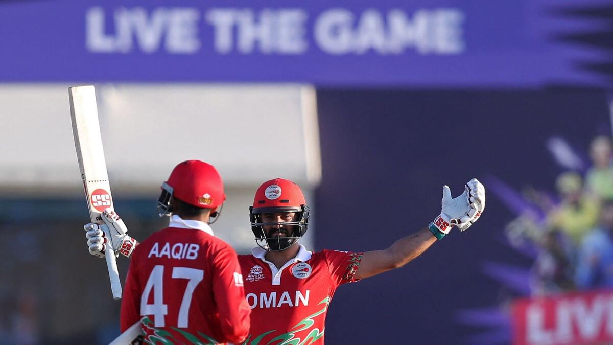 Oman's Jatinder Singh (right) and Aqib Ilyas celebrate their win against Papua New Guinea. (AFP)