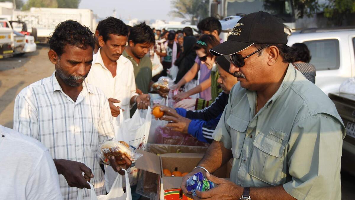 Care2Share distributing bags of food and other daily use items to the laborers at industrial area no 3 in Sharjah on Friday morning – Photo by M.Sajjad