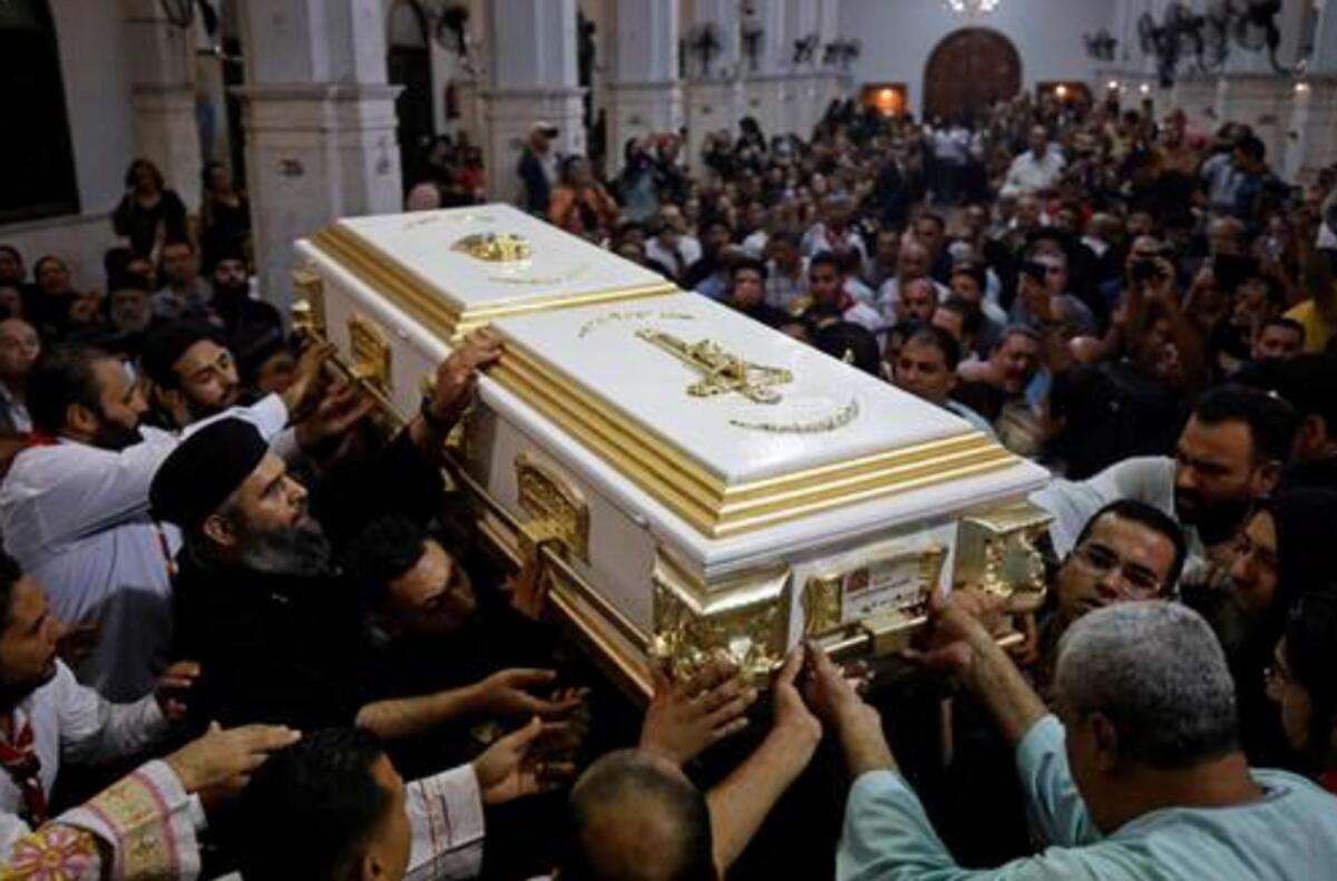Egyptian mourners attend the funeral of victims killed in Cairo Coptic church fire (Photo by AFP)