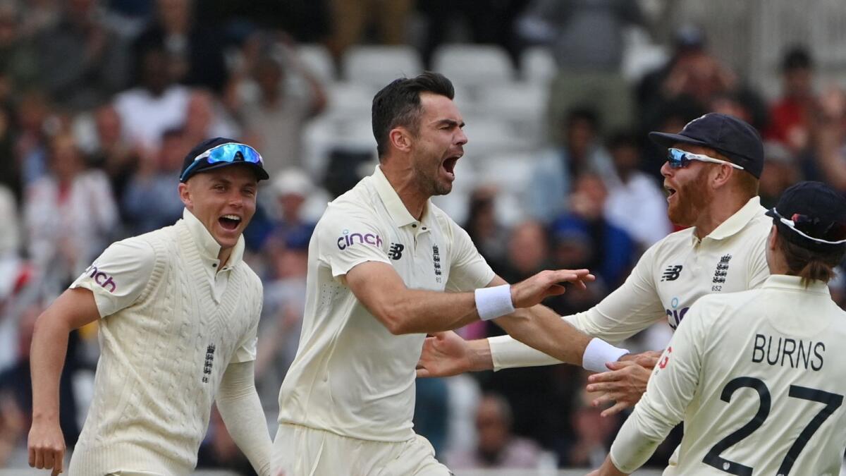 England's James Anderson (centre) celebrates after taking the wicket of Indian captain Virat Kohli. (AFP)