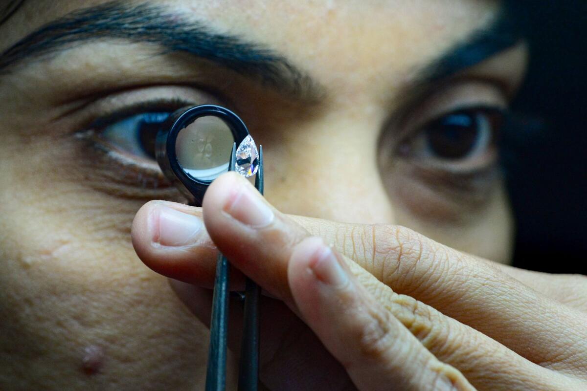 An mployee working at Greenlab Diamonds, a firm manufacturing lab-grown gems on the outskirts of Surat. — AFP