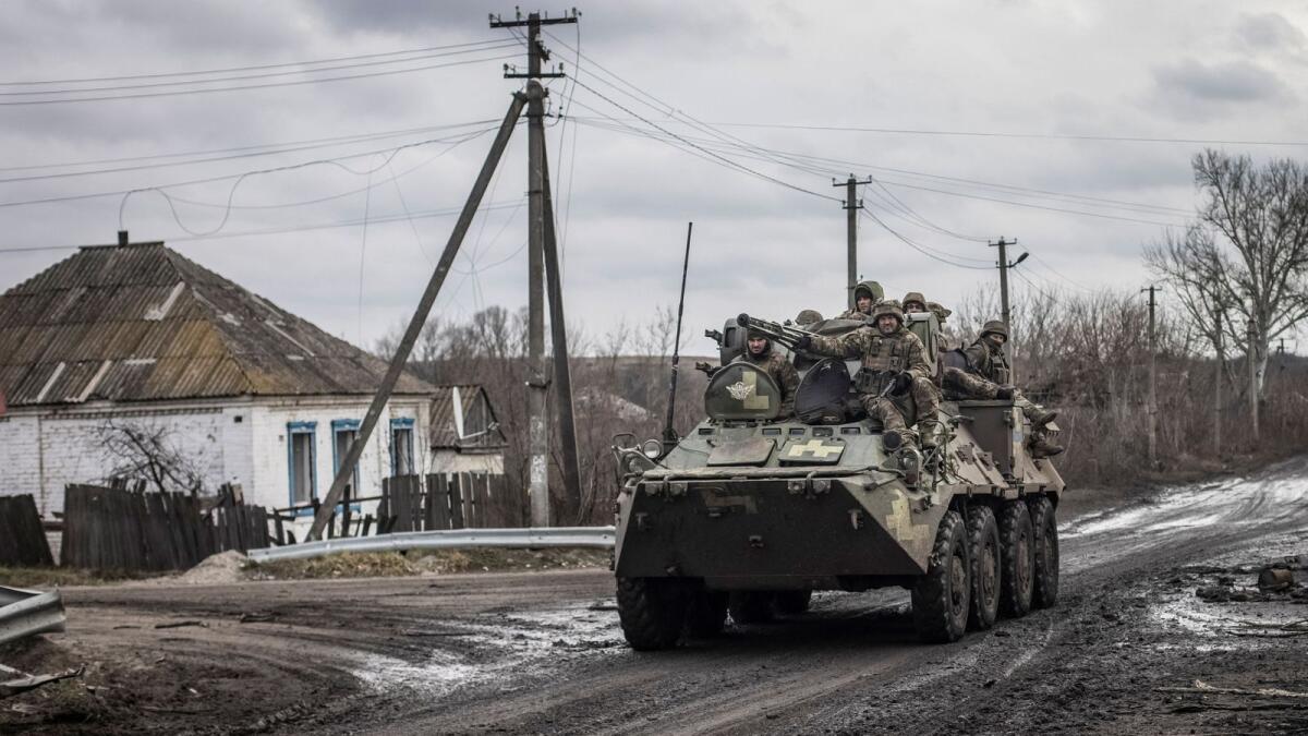 Ukrainian servicemen ride an Armoured Personnel Carrier (APC) in the village of Torske, Donetsk region. — Reuters