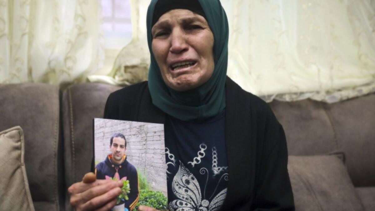 Rana, mother of Iyad Halak, 32, holds his photo at their home in East Jerusalem's Wadi Joz.