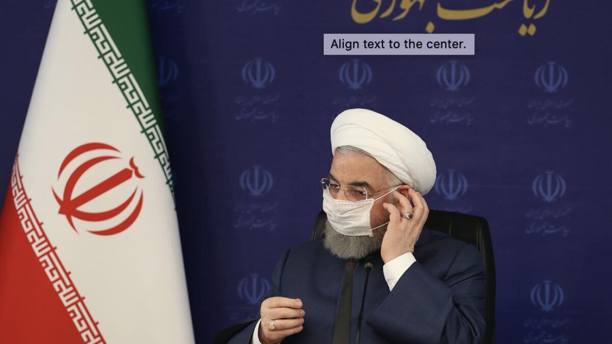 In this photo released by the official website of the office of the Iranian Presidency, President Hassan Rouhani adjusts his face mask in a meeting of the national headquarters of the fight against the Covid-19, in Tehran, Iran. He estimated as many as 25 million Iranians could have been infected with the coronavirus since the outbreak's beginning, citing an Iranian Health Ministry study that has so far not been made public, the state-run IRNA news agency reported. Writing in Farsi at top right reads, 'The Presidency.' Photo: AP