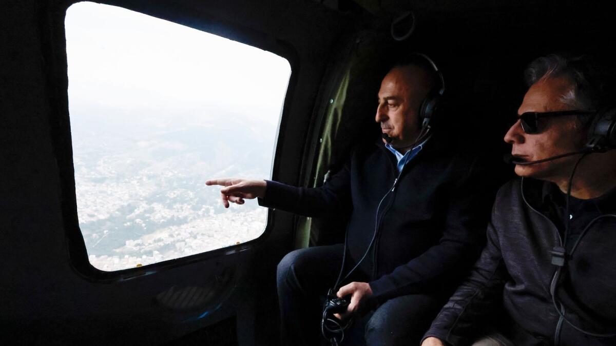 US Secretary of State Antony Blinken, right, and Turkish Foreign Minister Mevlut Cavusoglu sit in a helicopter for a tour of earthquake stricken areas in Turkey on Sunday. — AP