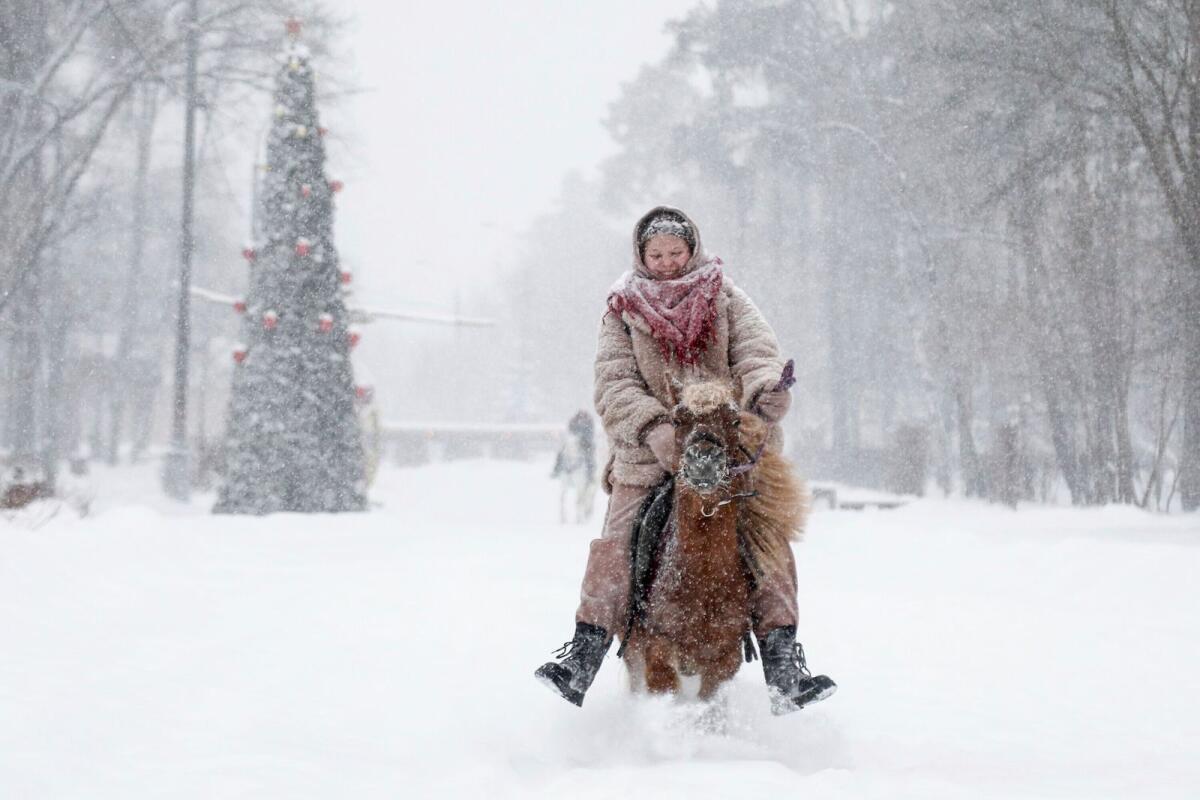 A woman rides a pony in a park during heavy snowfall in Moscow, Russia, Sunday, Dec. 3, 2023. Photo: AP