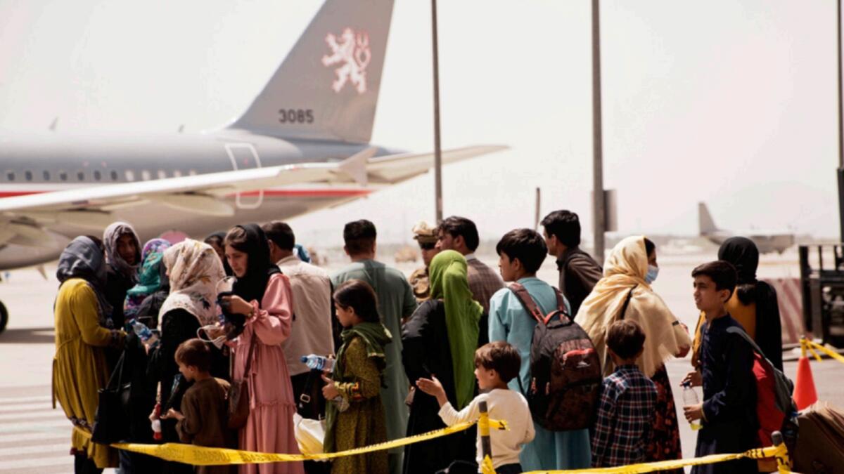 Afghan civilians prepare to board a plane during an evacuation at Hamid Karzai International Airport. —AP