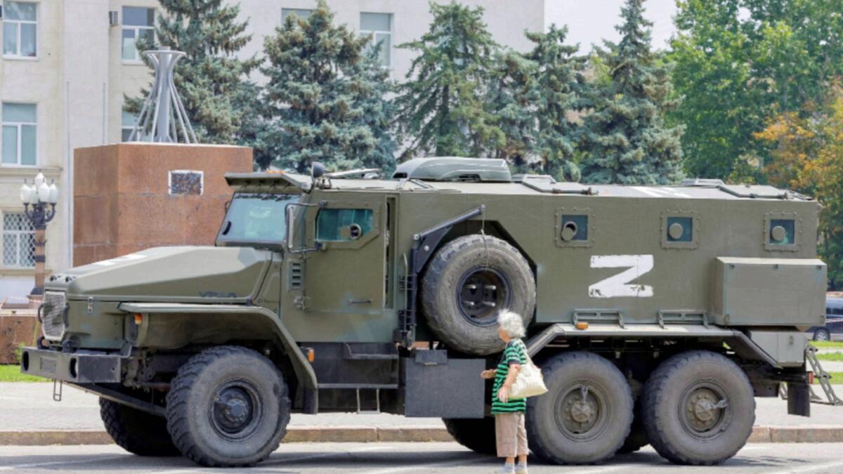 An armoured truck of pro-Russian troops is parked near Ukraine's former regional council's building during Ukraine-Russia conflict in the Russia-controlled city of Kherson. — Reuters file