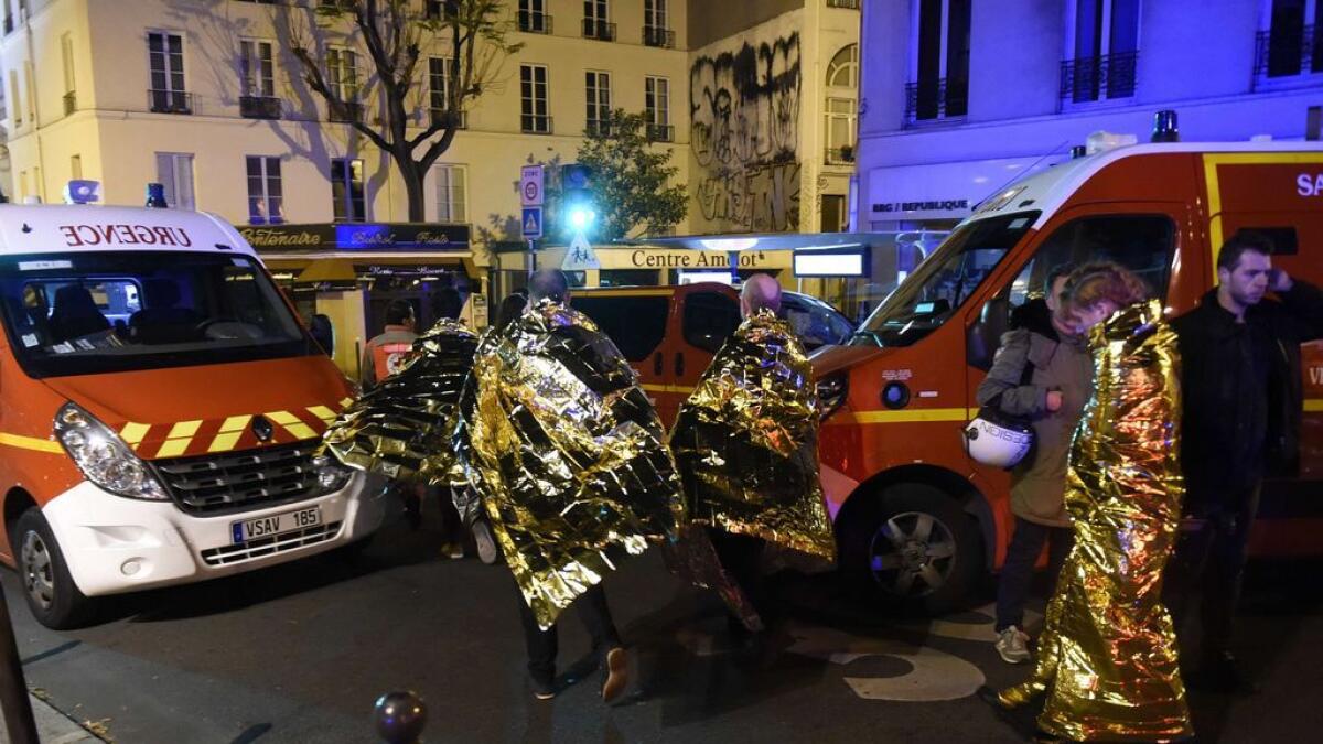 People are being evacuated on rue Oberkampf near the Bataclan concert hall in central Paris.