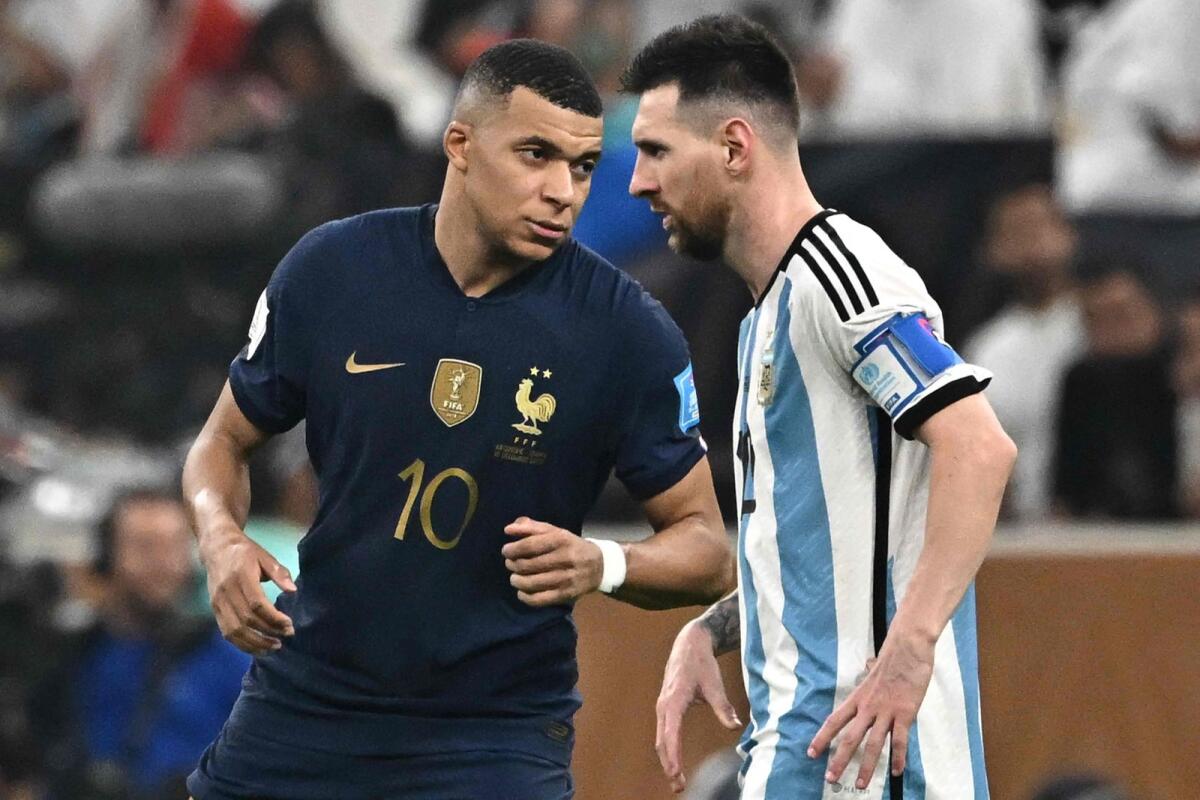 France's Kylian Mbappe (left) with Argentina's Lionel Messi during the World Cup final in Lusail, Qatar, on December 18. — AFP