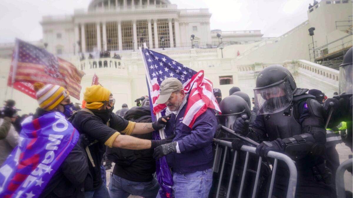 Rioters try to break through a police barrier at the Capitol in Washington on Jan. 6, 2021. — AP file