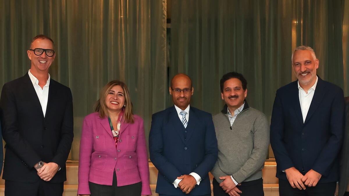 Dr Mohammed Hamad Al-Kuwaiti, flanked by Reem Asaad (left) and Raj Chopra, with other officials at the launch event. — Supplied photo