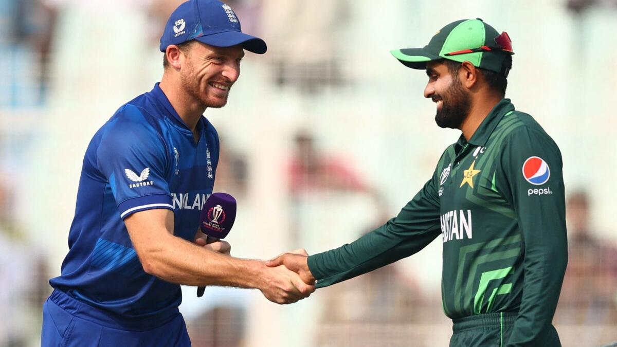 England's Jos Buttler and Pakistan's Babar Azam shake hands before the match. Reuters