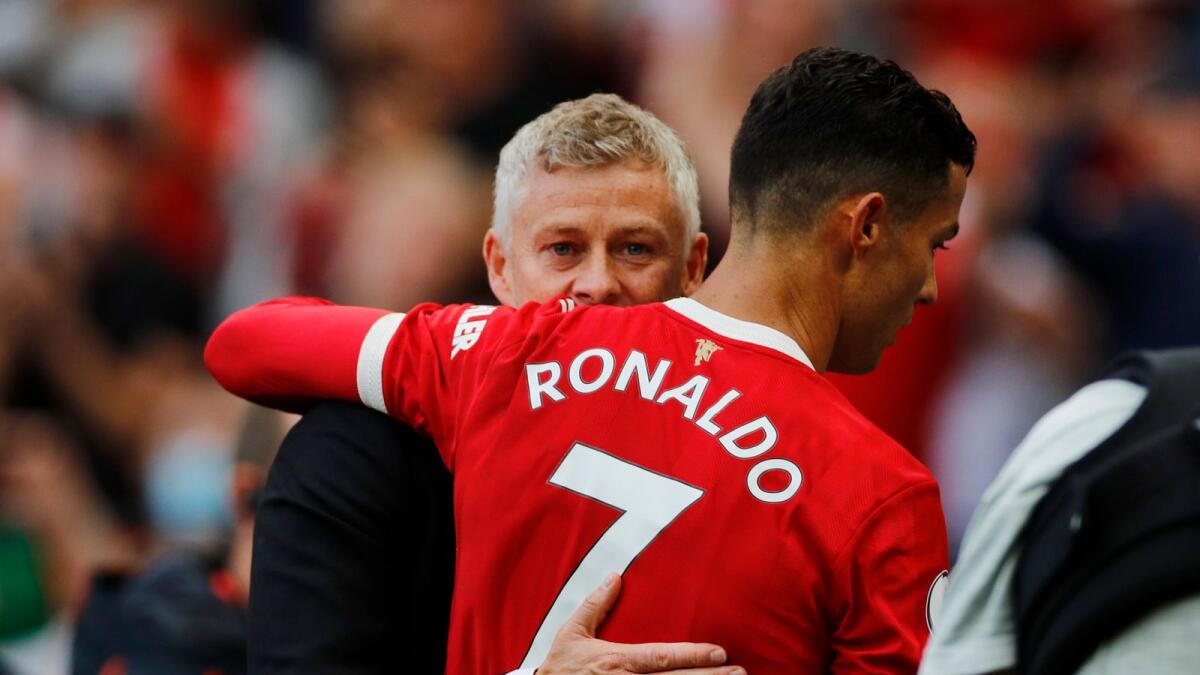 Manchester United's Cristiano Ronaldo and manager Ole Gunnar Solskjaer celebrate after the match.— Reuters