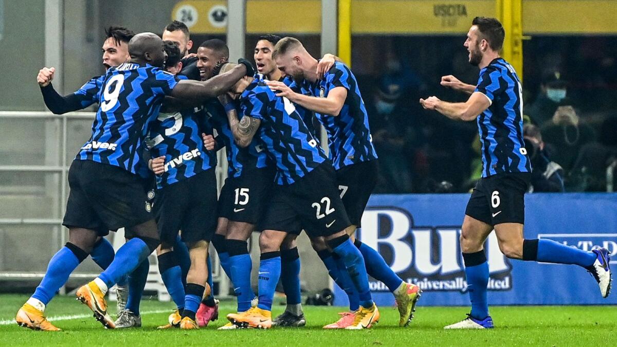 Inter Milan's Argentine forward Lautaro Martinez (rear left) and teammates celebrate a goal against Juventus. — AFP