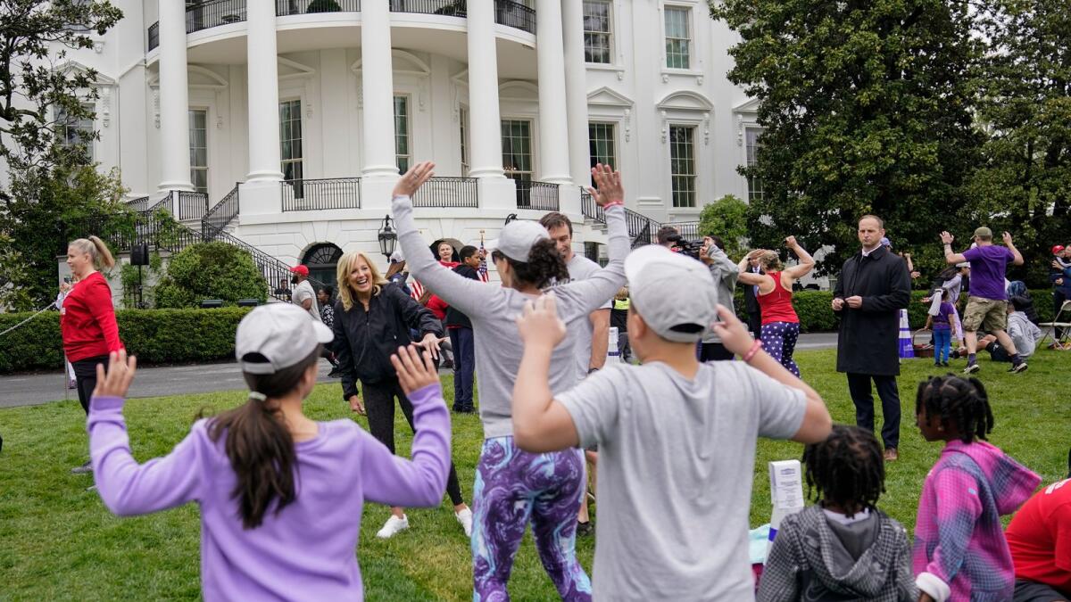 First lady Jill Biden walks though kids and families as they workout during the Joining Forces Military Kids Workout on the South Lawn of the White House in Washington on Saturday. — AP