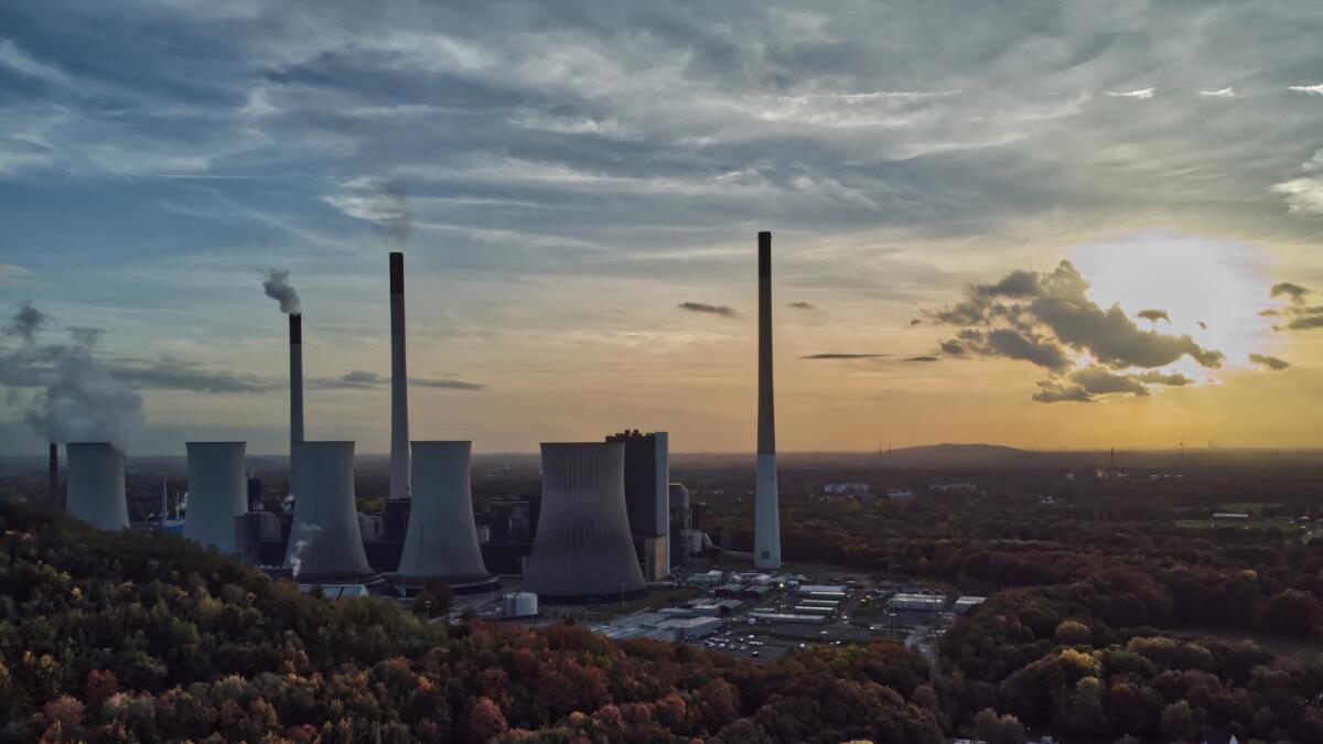 The sun sets behind the cole-fired power plant 'Scholven' of the Uniper energy company in Gelsenkirchen, Germany. The European economy contracted slightly at the end of last year and beginning of 2023, revised figures showed on Thursday. — AP