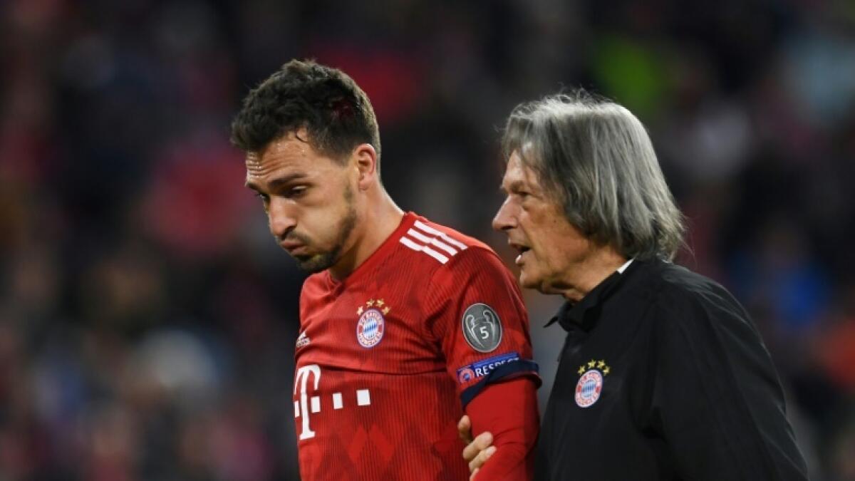 Hans-Wilhelm Mueller-Wohlfahrt pictured helping Mats Hummels off the pitch when he played for Bayern Munich in October 2018. - AFP file