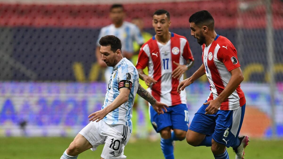 Argentina's Lionel Messi (left) and Paraguay's Junior Alonso vie for the ball during their Copa America match in Brasilia on on Monday. (AFP)