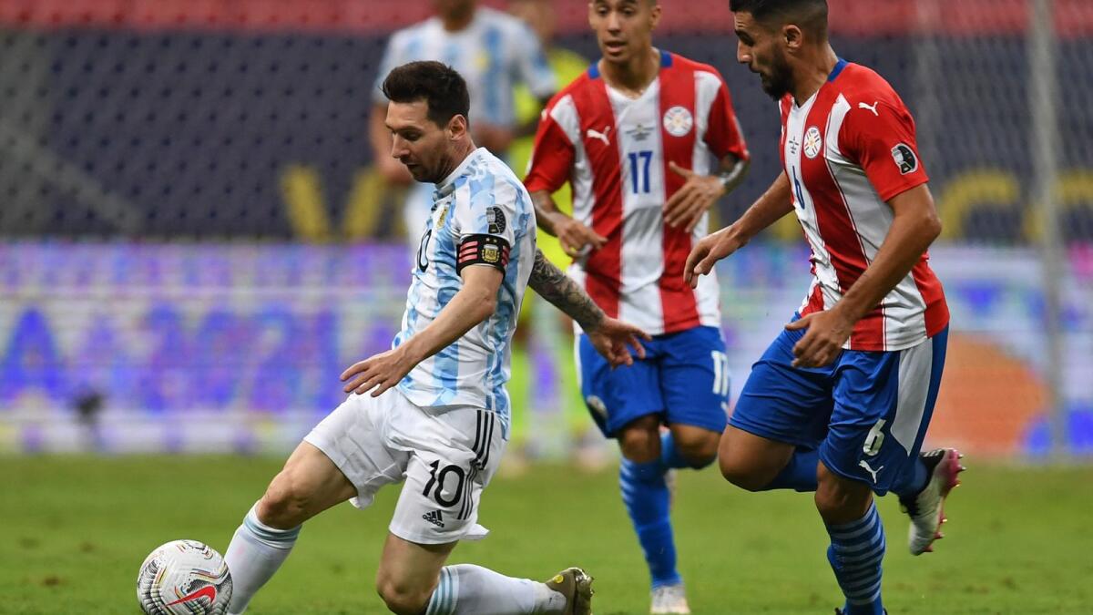 Argentina's Lionel Messi (left) and Paraguay's Junior Alonso vie for the ball during their Copa America match in Brasilia on on Monday. (AFP)