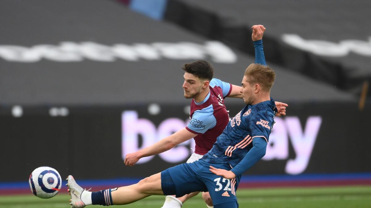 West Ham's Declan Rice (left) challenges for the ball with Arsenal's Emile Smith Rowe during the English Premier League match. — AP
