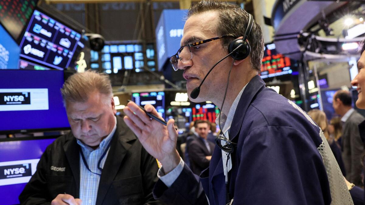 Traders work on the floor of the New York Stock Exchange . - Reuters file
