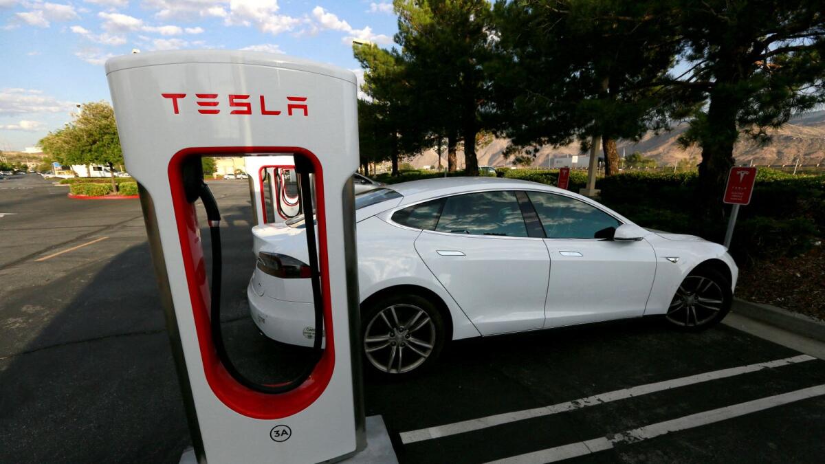 A Tesla Model S charges at a Tesla supercharger station in Cabazon, California. Tesla stock is down about half from their November 2021 peaks, but has rebounded more than 60 per cent this year. — Reuters