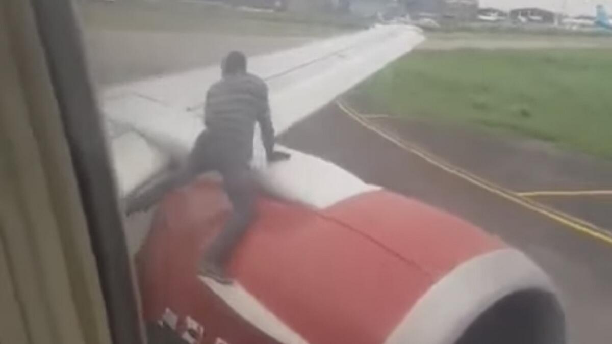 Video: Man climbs onto plane wing before takeoff