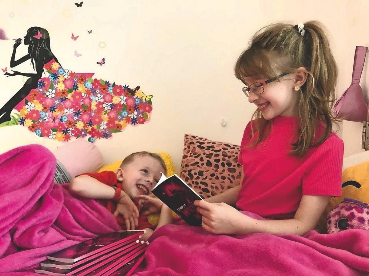 Kids in bed reading books