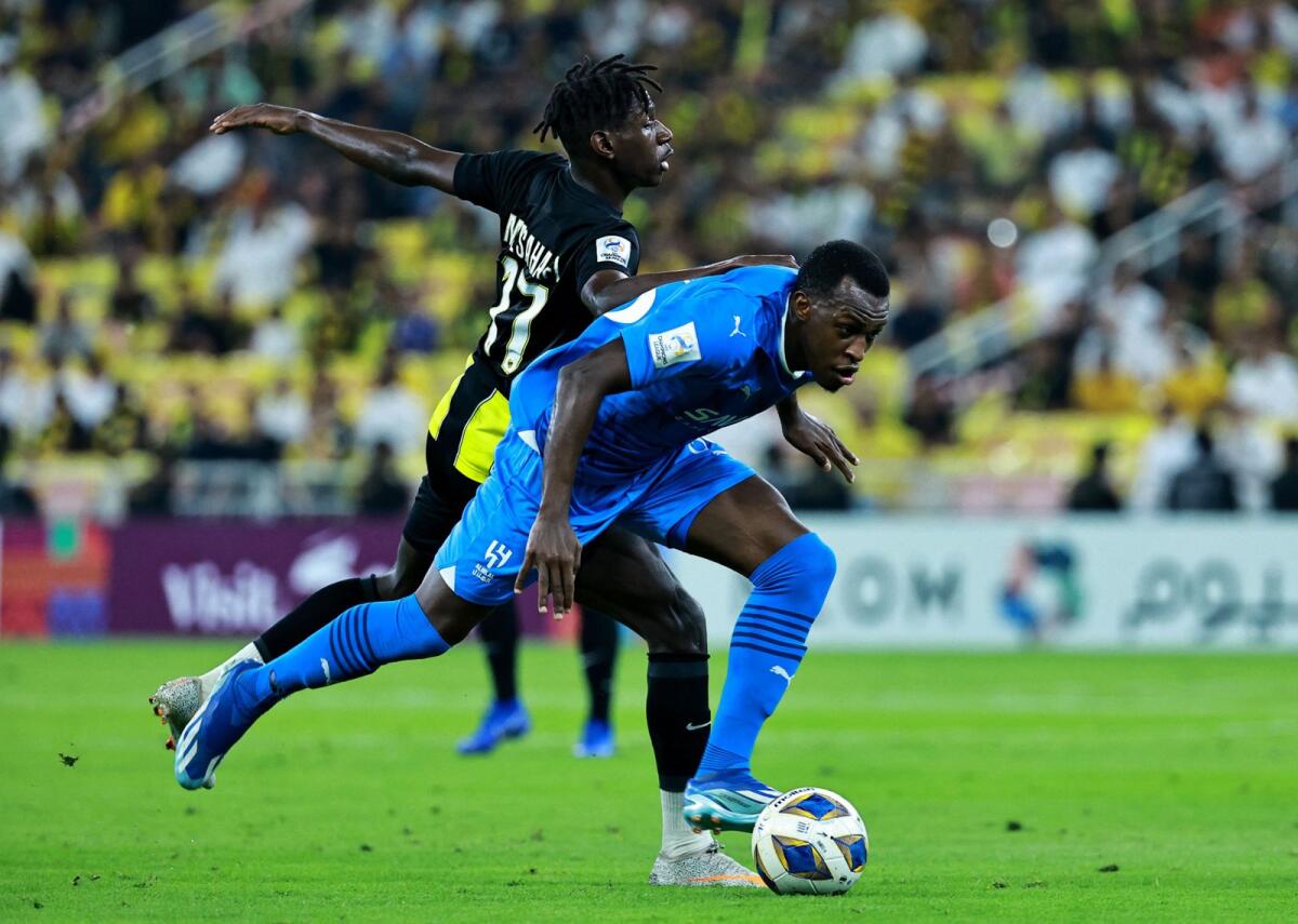 Al Ittihad's Marwan Al Sahafi vies for the ball with Al Hilal's Kalidou Koulibaly. — Reuters