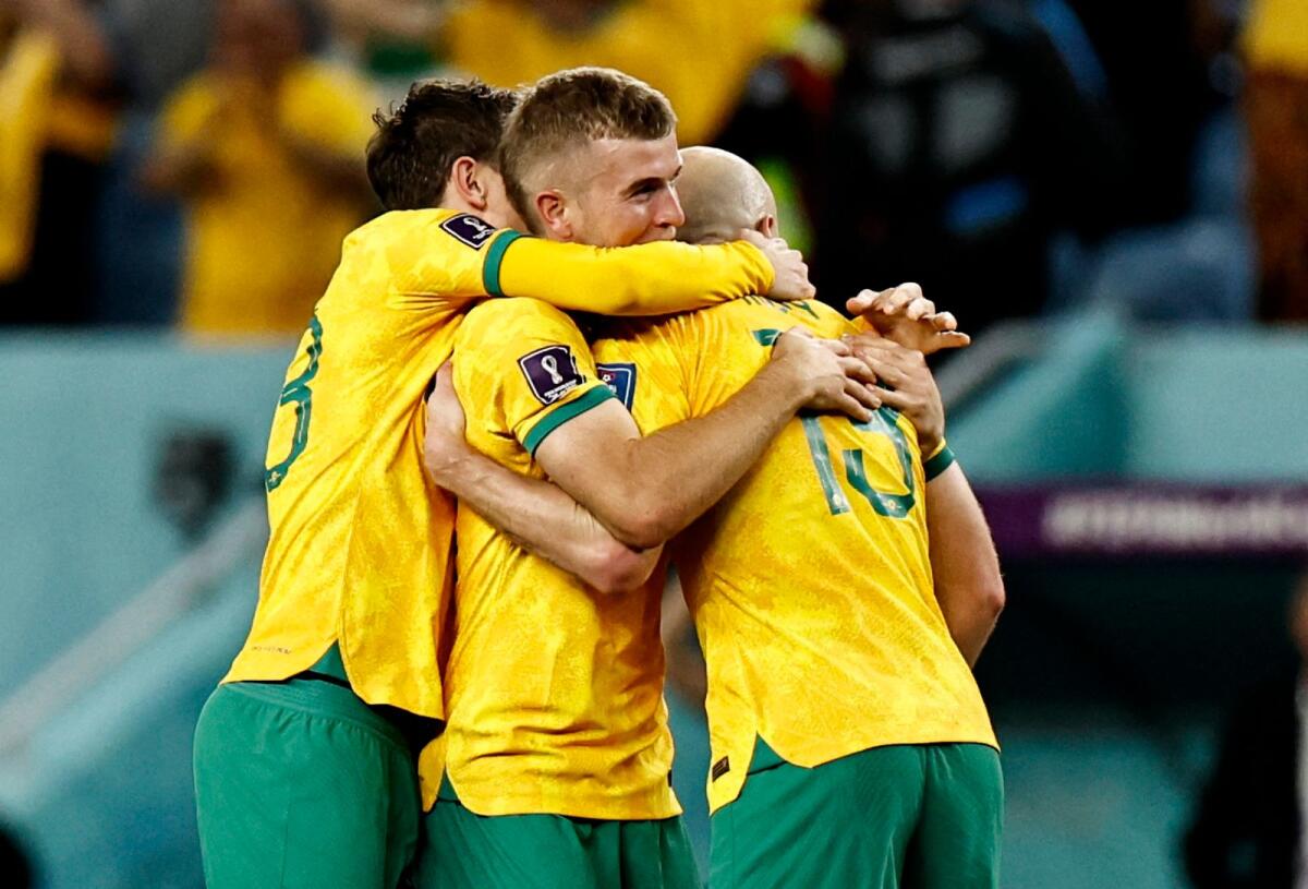Australia players celebrate qualifying for the knockout stages. Photo: Reuters