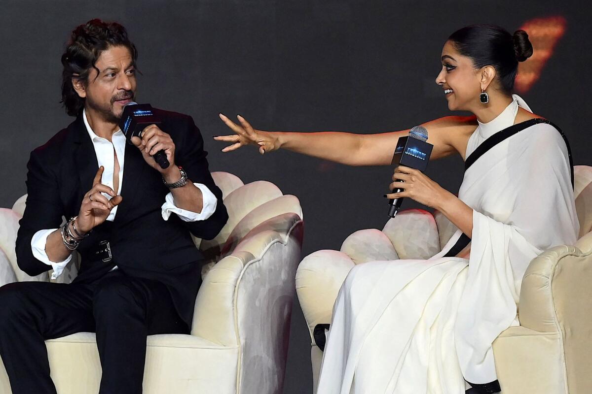 Bollywood actors Shah Rukh Khan (L) and Deepika Padukone speak during an event to celebrate the success of their Indian Hindi-language action thriller film ‘Jawan’ in Mumbai on September 15, 2023. Photo: AFP